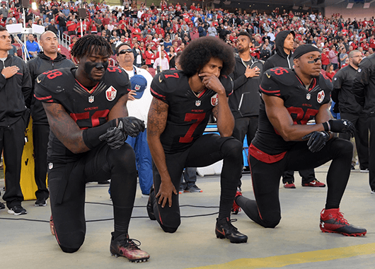San Francisco 49ers Eli Harold, Colin Kaepernick, and Eric Reid kneel before a game against the Arizona Cardinals, October 07, 2016 (Source: Kirby Lee/The Nation)